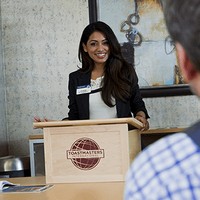Woman giving a presentation behind a lectern 