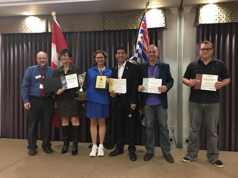 Humorous Speech Contest winners, Renne, Benny and Stefano stand with the District Trio.